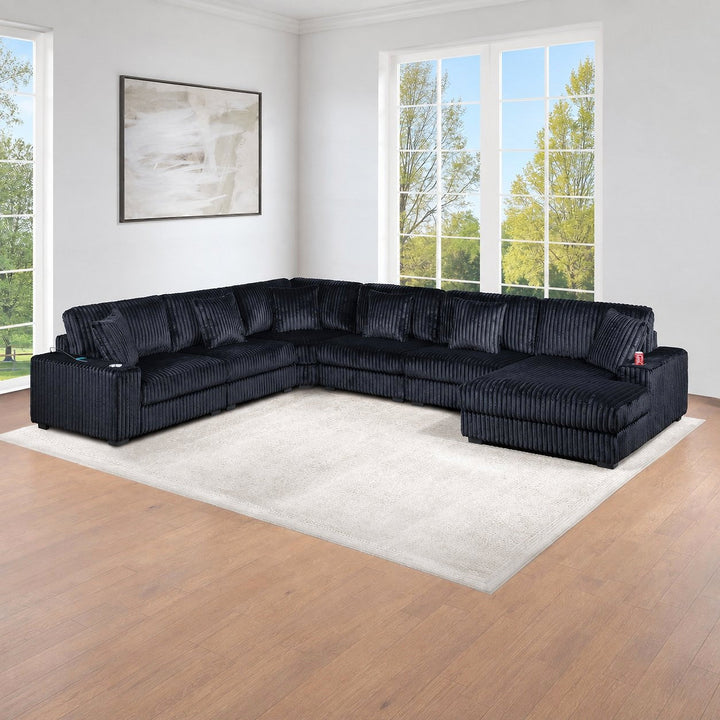 Black corduroy modular sectional with a chaise in a bright living room