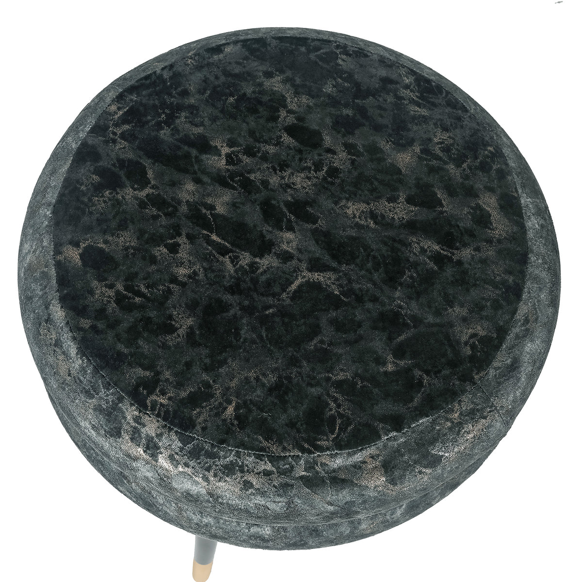 Overhead view of the ottoman's patterned round velvet cushion