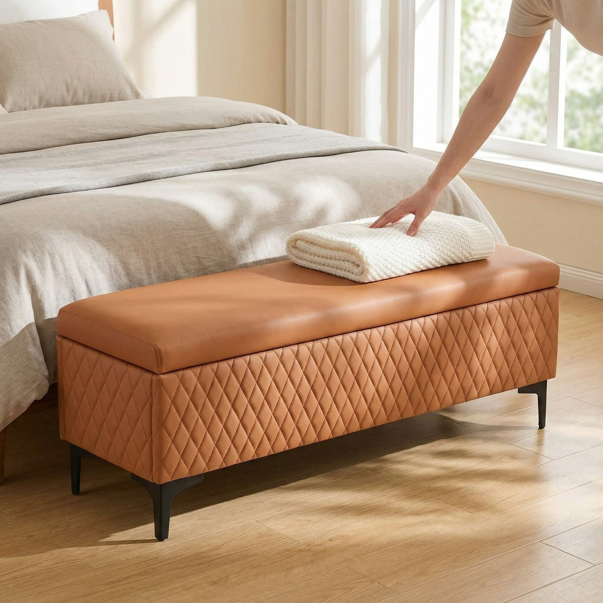 Brown diamond-quilted bench with dark legs at the foot of a bed