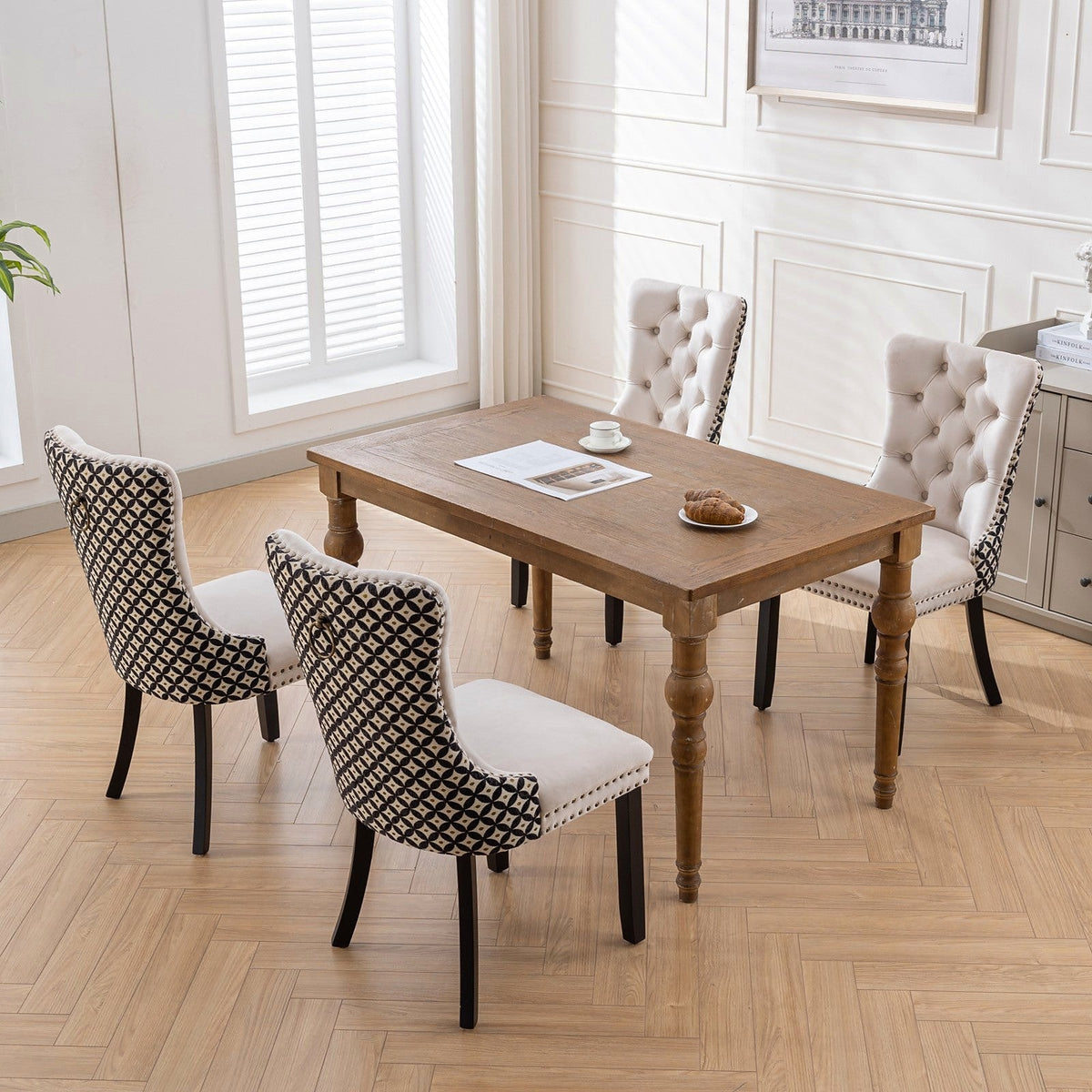 Beige velvet dining chair with a patterned back and dark wood legs