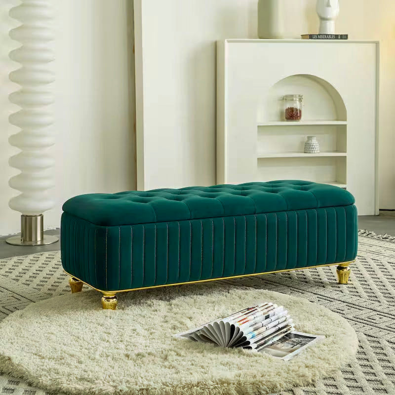 Angled view of the green upholstered bench showing its rounded lid and gold-tone edging