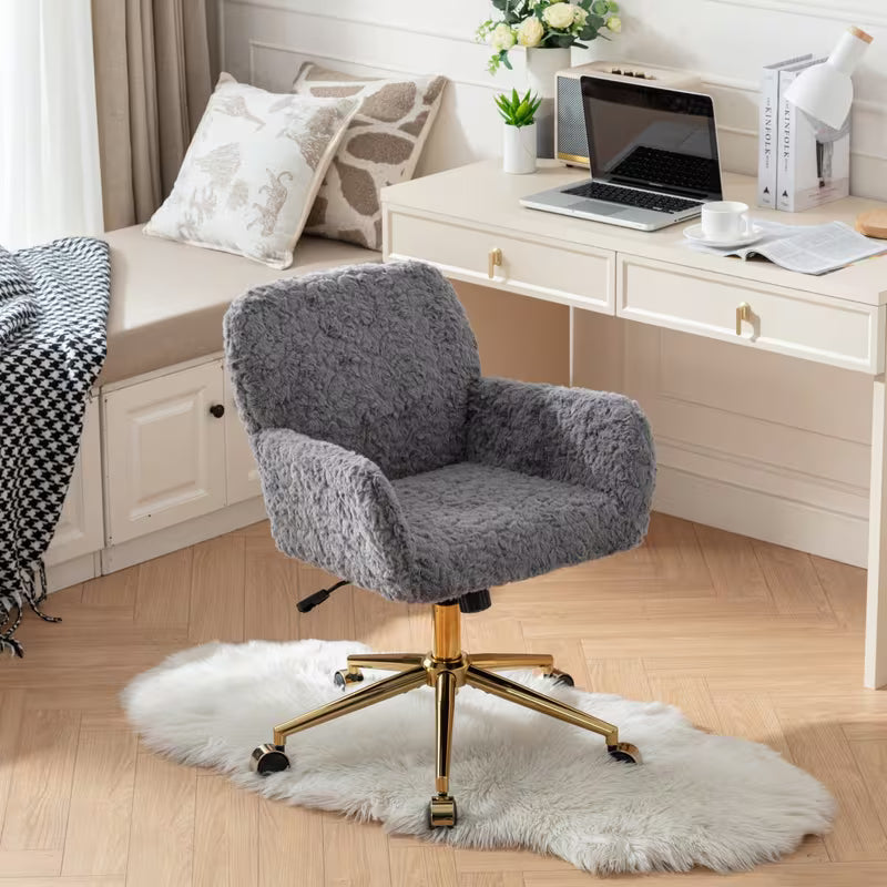 Angled view of the gray faux alpaca chair beside a desk