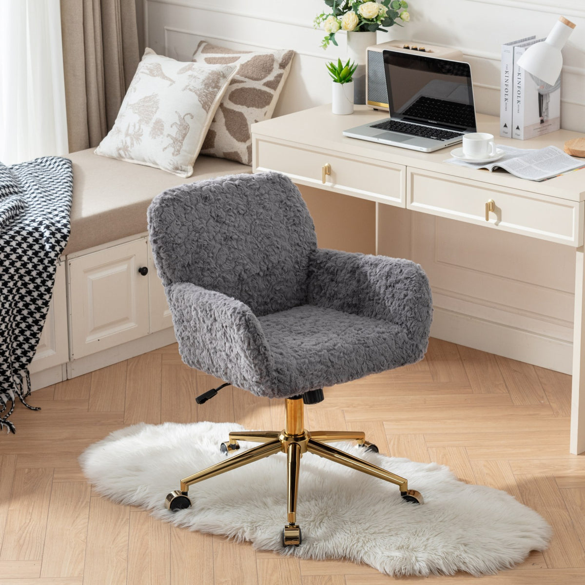 Gray faux alpaca chair showing padded arms and wheeled base