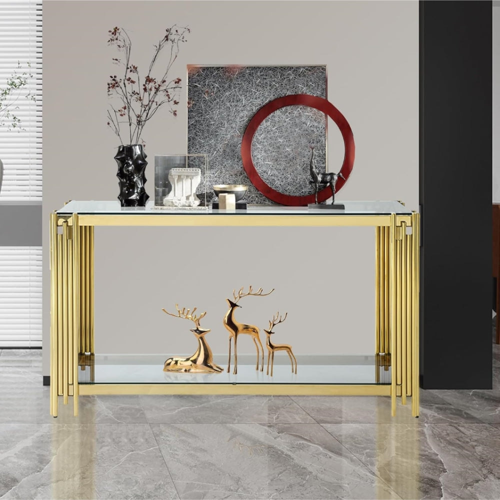 Clear glass and gold console styled with decorative vases and sculptures.