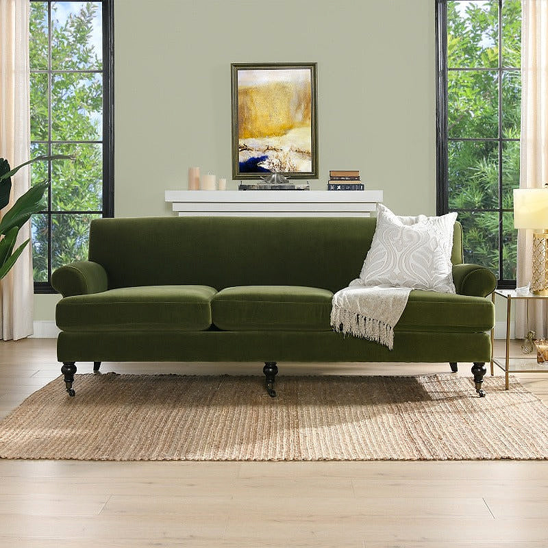 Alana olive green velvet sofa, front view in a living room