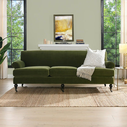 Alana olive green velvet sofa, front view in a living room
