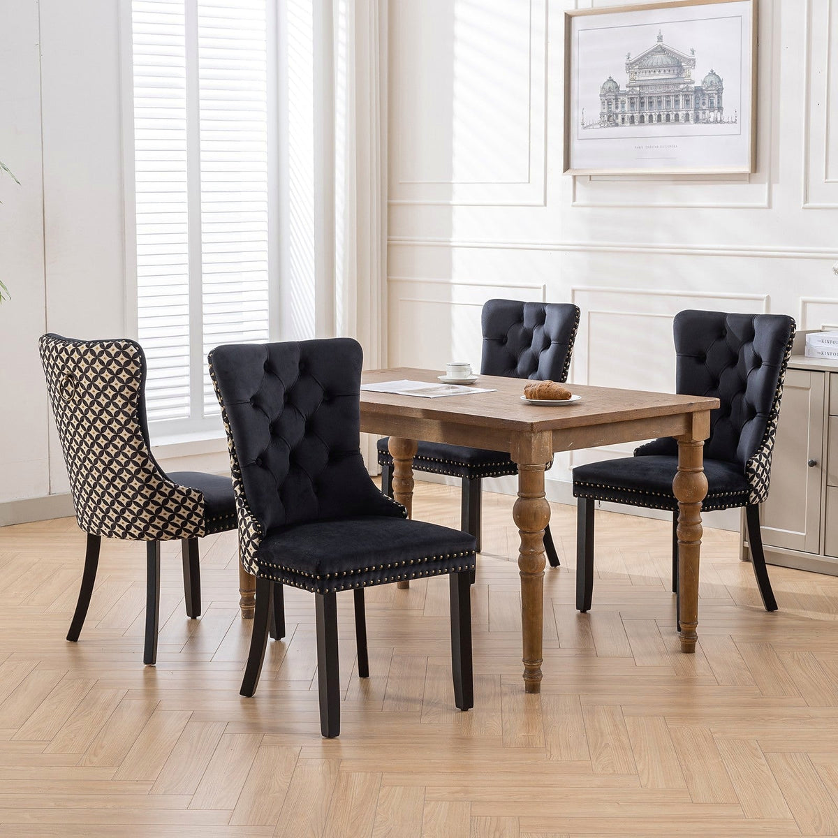 Black velvet dining chair with a patterned back and dark wood legs