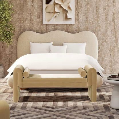 Mason beige upholstered bench with two bolster pillows at the foot of a bed
