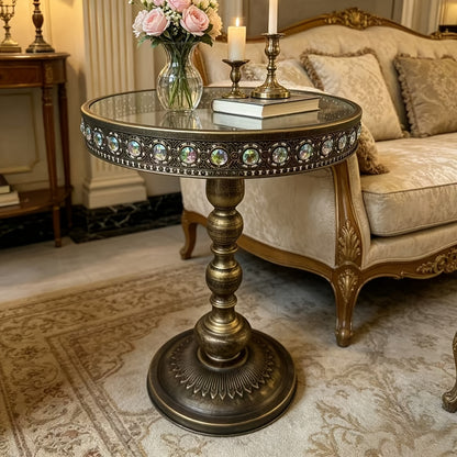 Angled view of the bronze side table showing the jeweled tabletop rim.