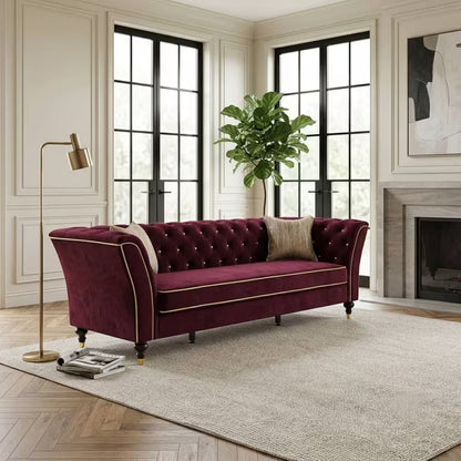 Chesterfield Sofa with Contrast Piping — burgundy sofa beside a fireplace.