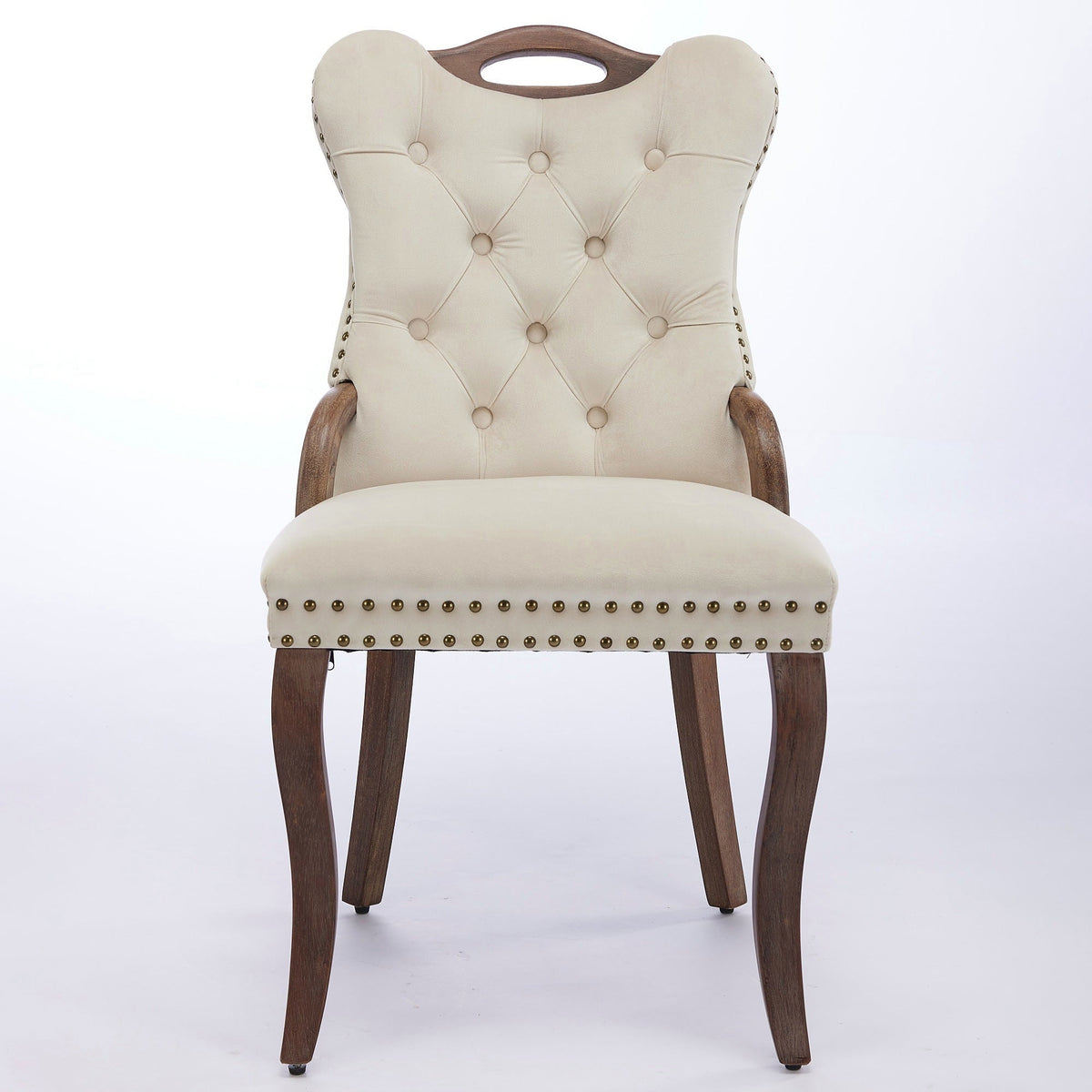 Beige velvet dining chair with a tufted back, wood handle, and curved wood legs