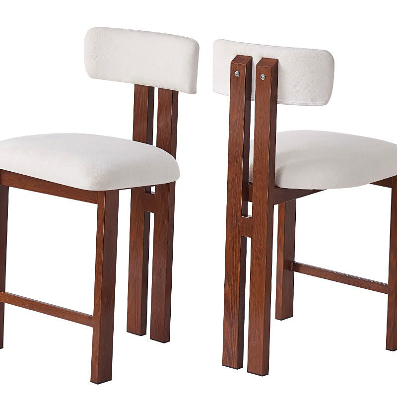 White upholstered counter stool with a brown frame and integrated footrest