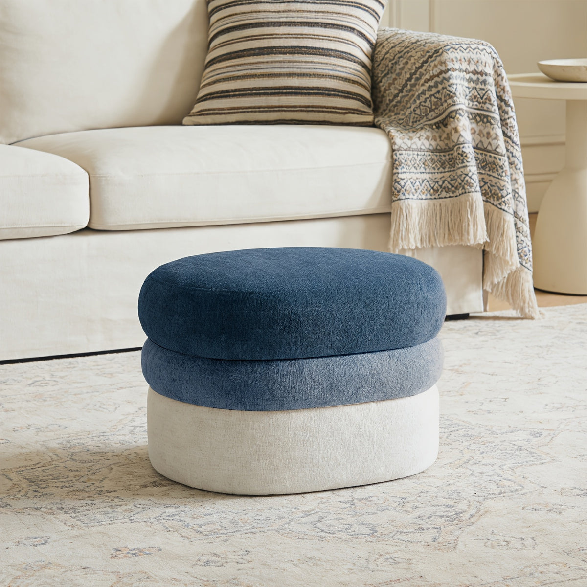 Blue-and-cream ombre ottoman beside sofa