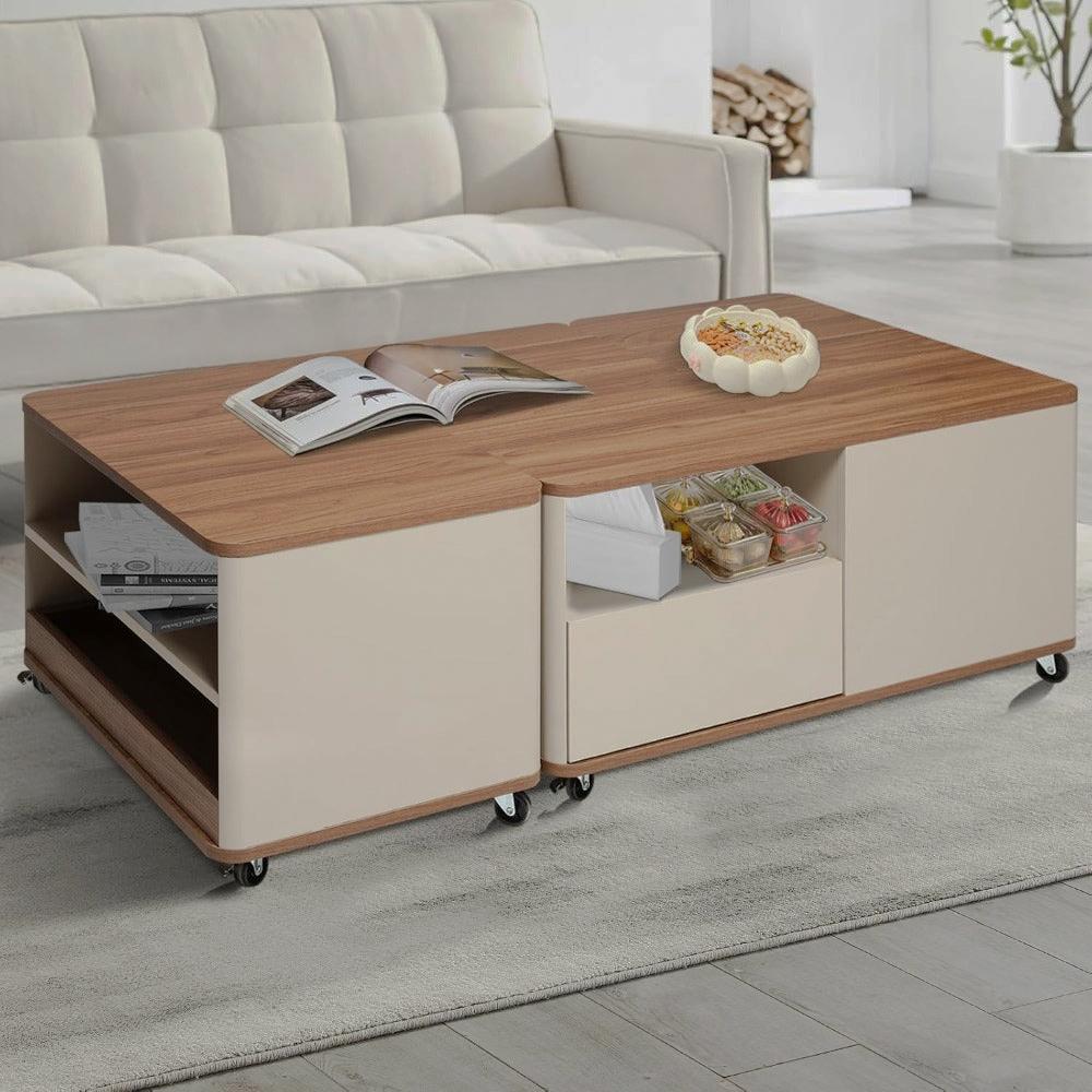 Angled view of the beige storage coffee table with open drawers and caster wheels