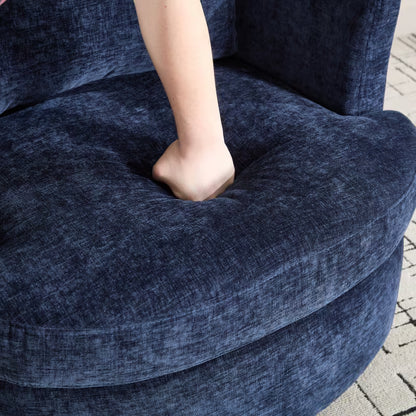 Hand pressing the navy chair's seat cushion