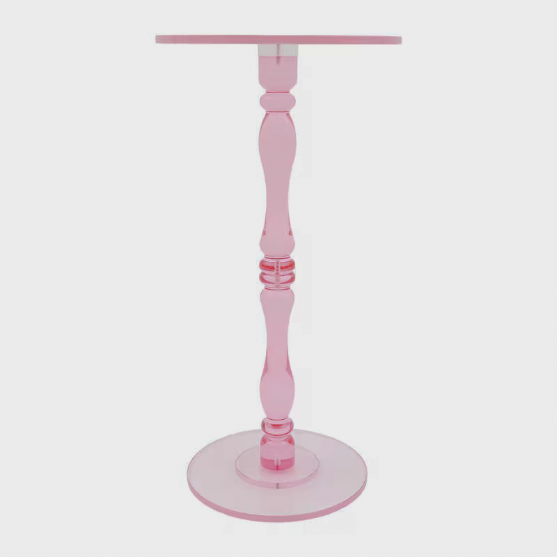 Close-up of the pink acrylic table's shaped pedestal stem