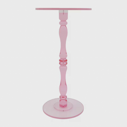 Close-up of the pink acrylic table's shaped pedestal stem