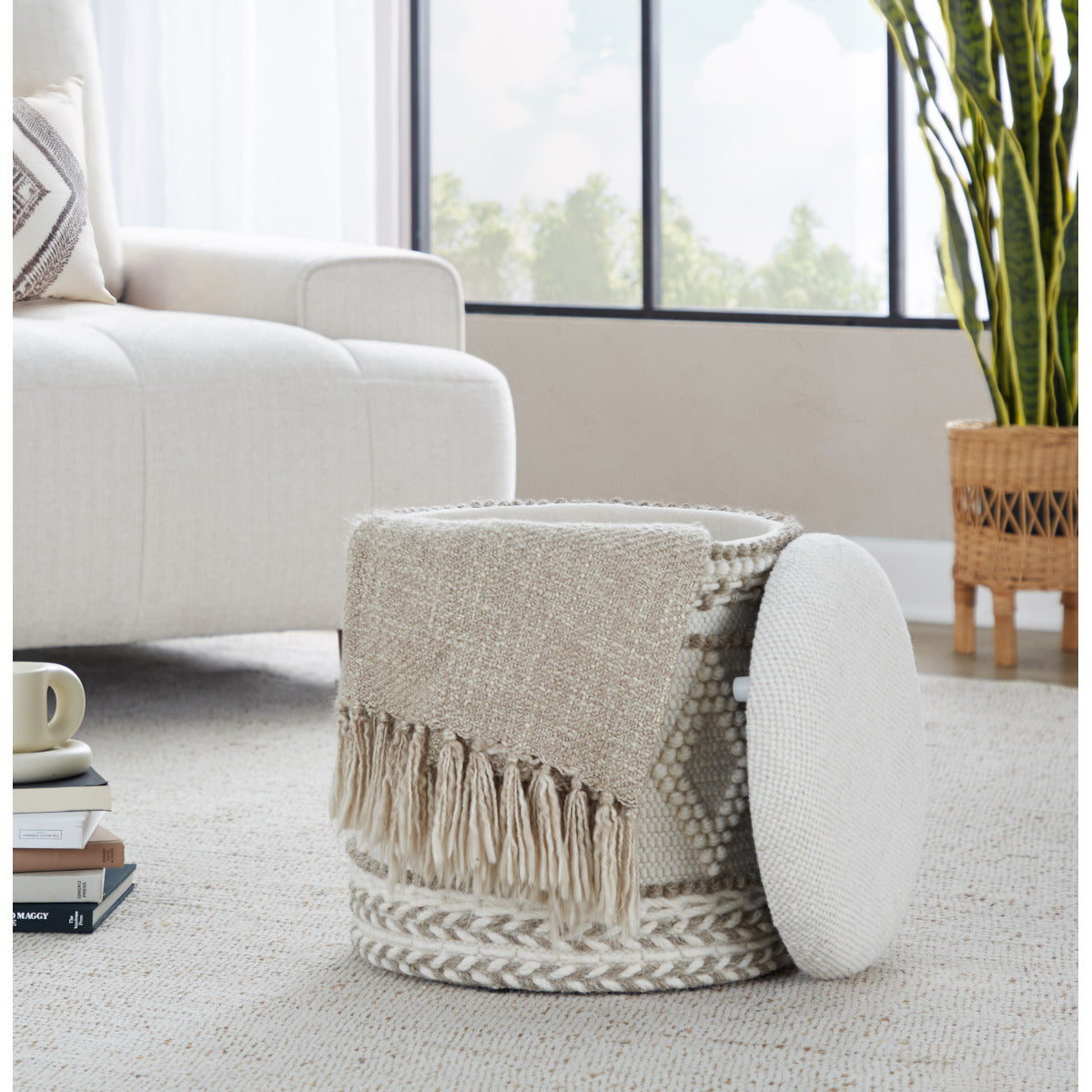 Open patterned ottoman with lid and throw draped over side