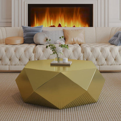 Faceted gold-tone geometric coffee table in front of a cream tufted sofa
