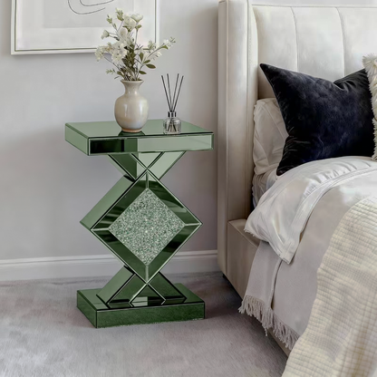 Green mirrored side table beside an upholstered bed