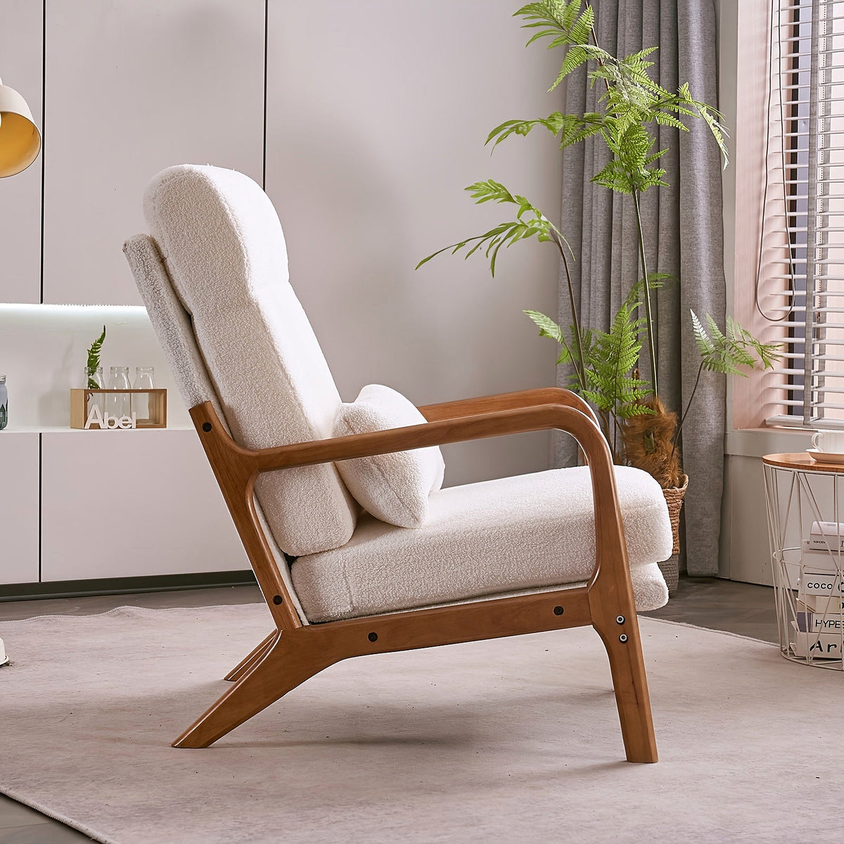 White high back upholstered lounge chair with a warm wood frame