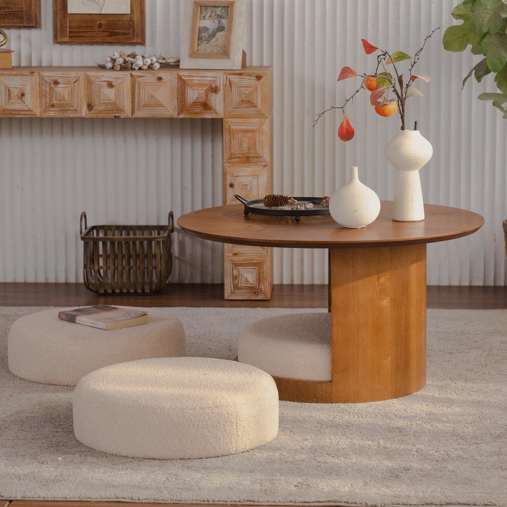 Round coffee table beside three cream stools in a coordinated living area