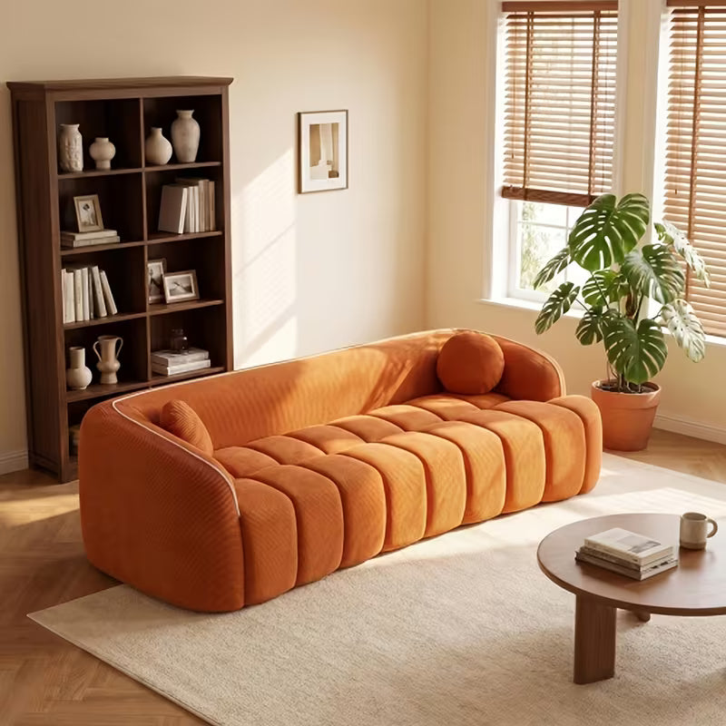 Channel-Tufted Corduroy Lounge Sofa — orange sofa three-quarter view.