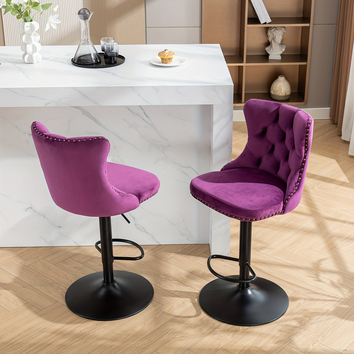 Angled views of two purple velvet stools and pedestal bases