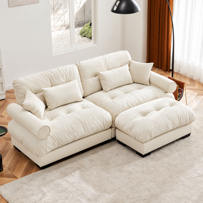 Cream Velvet Sofa with Matching Ottoman — cream sofa and ottoman in a living room.