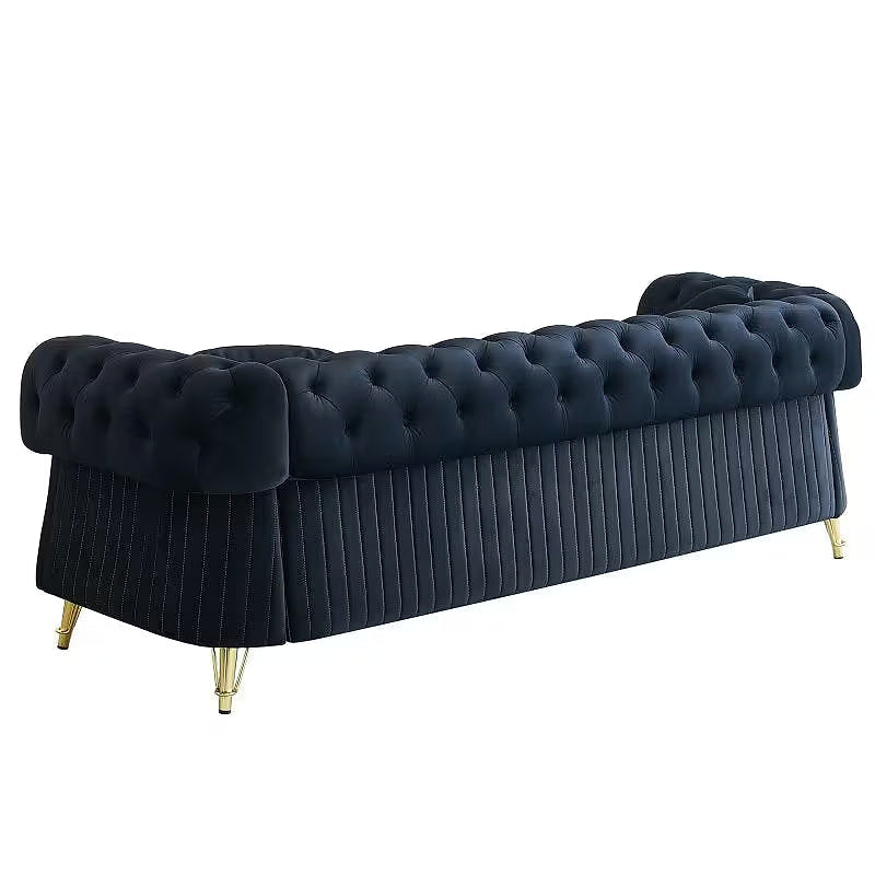Angled rear view of the black Chesterfield sofa with tufting and vertical channels