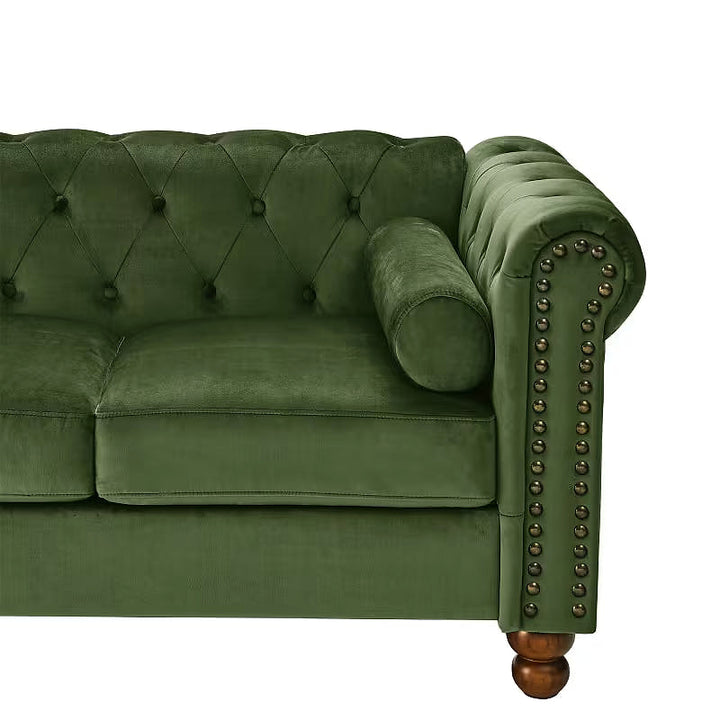 Close-up of the green loveseat seat, button-tufted back and bolster pillow