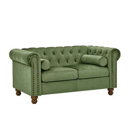Angled view of the green velvet Chesterfield loveseat on a white background