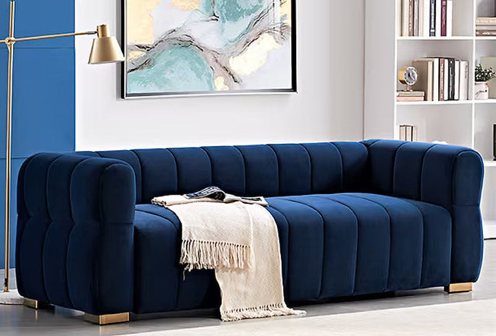 Soren blue velvet sofa with gold-tone feet, angled room view