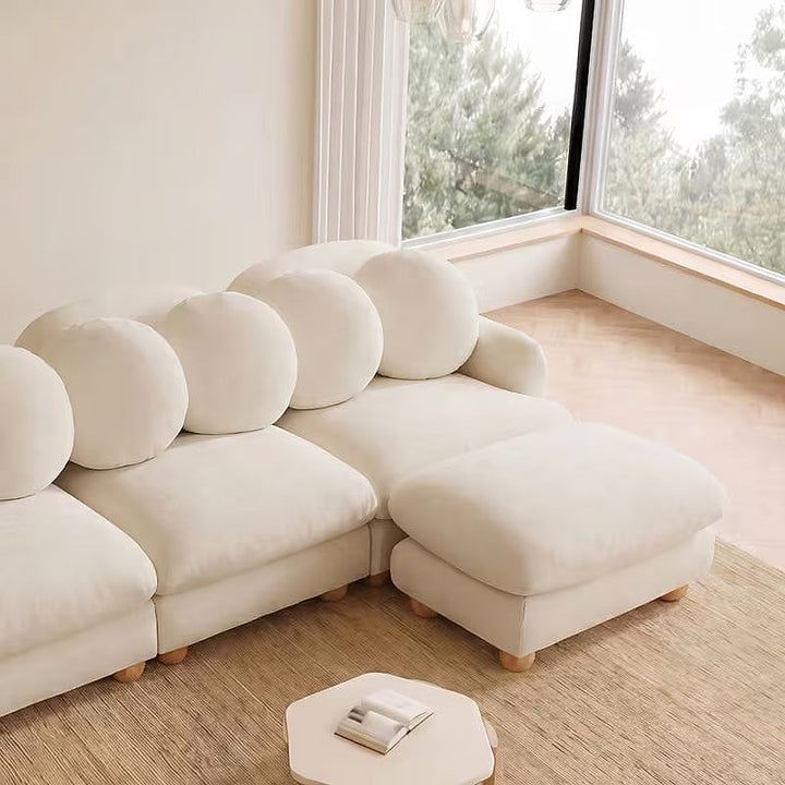 Clover beige loveseat styled with an ottoman, ottoman not included
