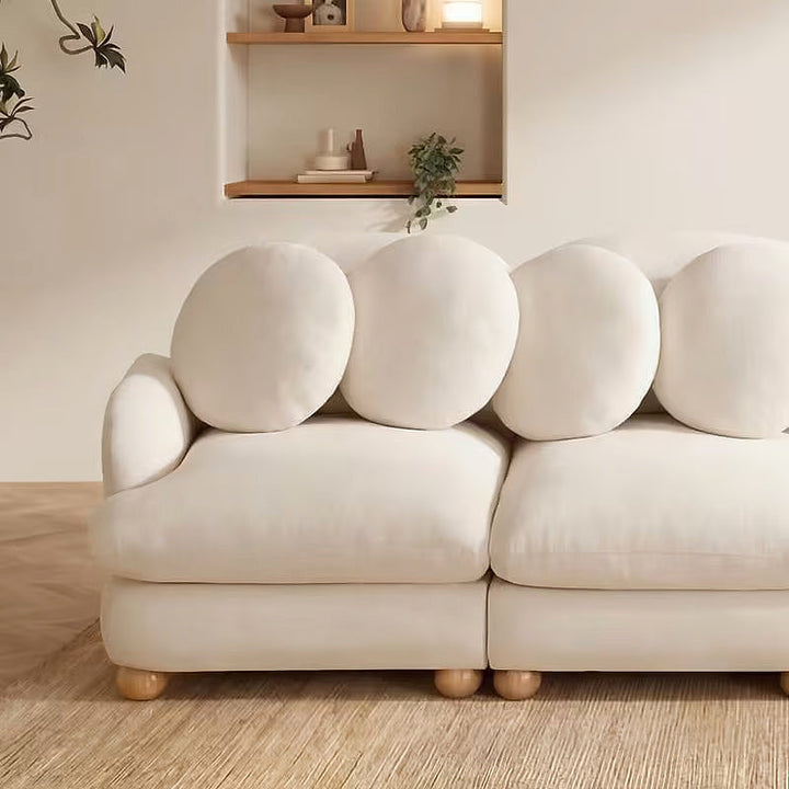Clover beige loveseat, close-up of circular pillows and seats