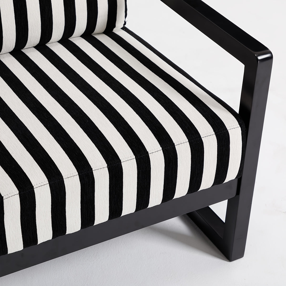 Black and White Striped Wood-Frame Lounge Chair — striped seat and black frame close-up