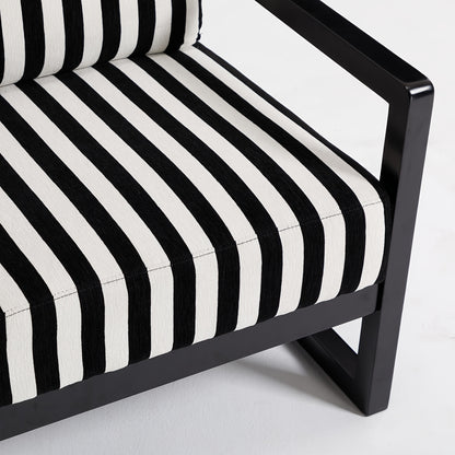 Black and White Striped Wood-Frame Lounge Chair — striped seat and black frame close-up