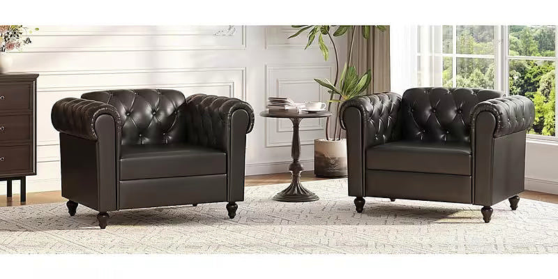 Black faux leather Chesterfield club chair with rolled arms and turned wood feet