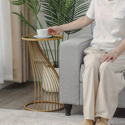 Gold-tone twisted side table by sofa
