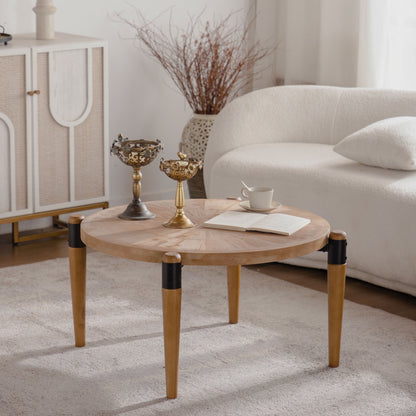 Round radial-pattern coffee table with tapered legs and black accents