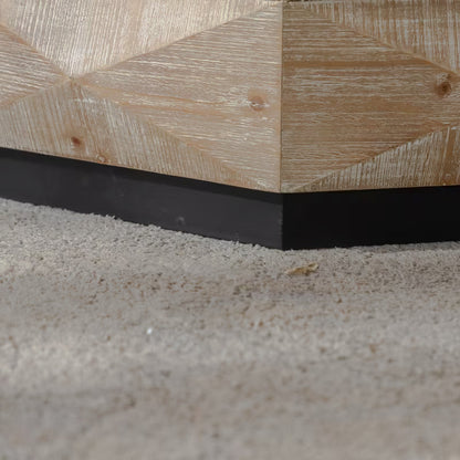 Close-up of a light faceted coffee table side above a black plinth base