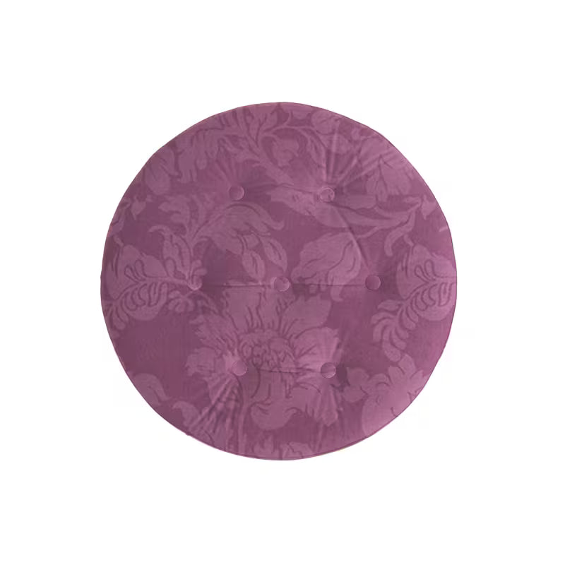 Top view showing the ottoman's purple floral pattern and tufting