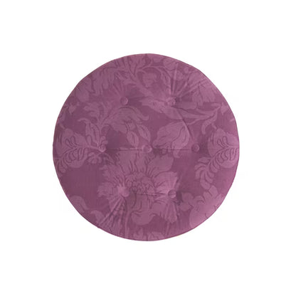Top view showing the ottoman's purple floral pattern and tufting