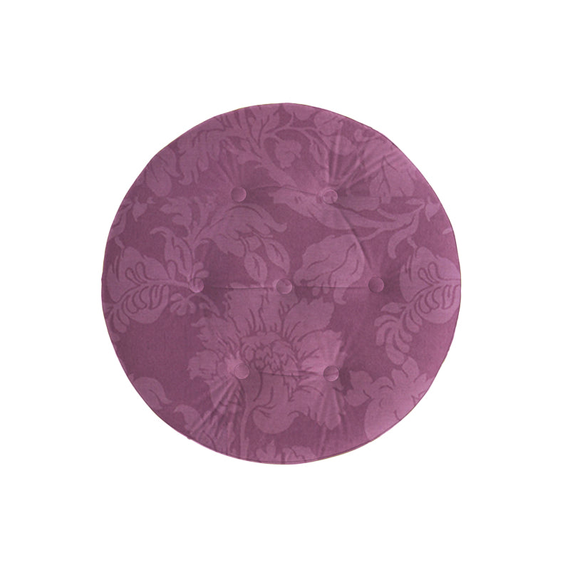 Overhead view of the purple ottoman's floral pattern and button tufting