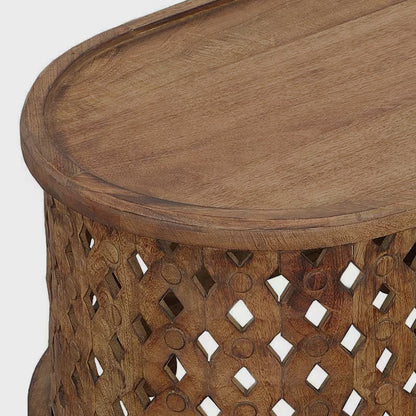 Close-up of the oval tabletop edge and carved cutout coffee table side