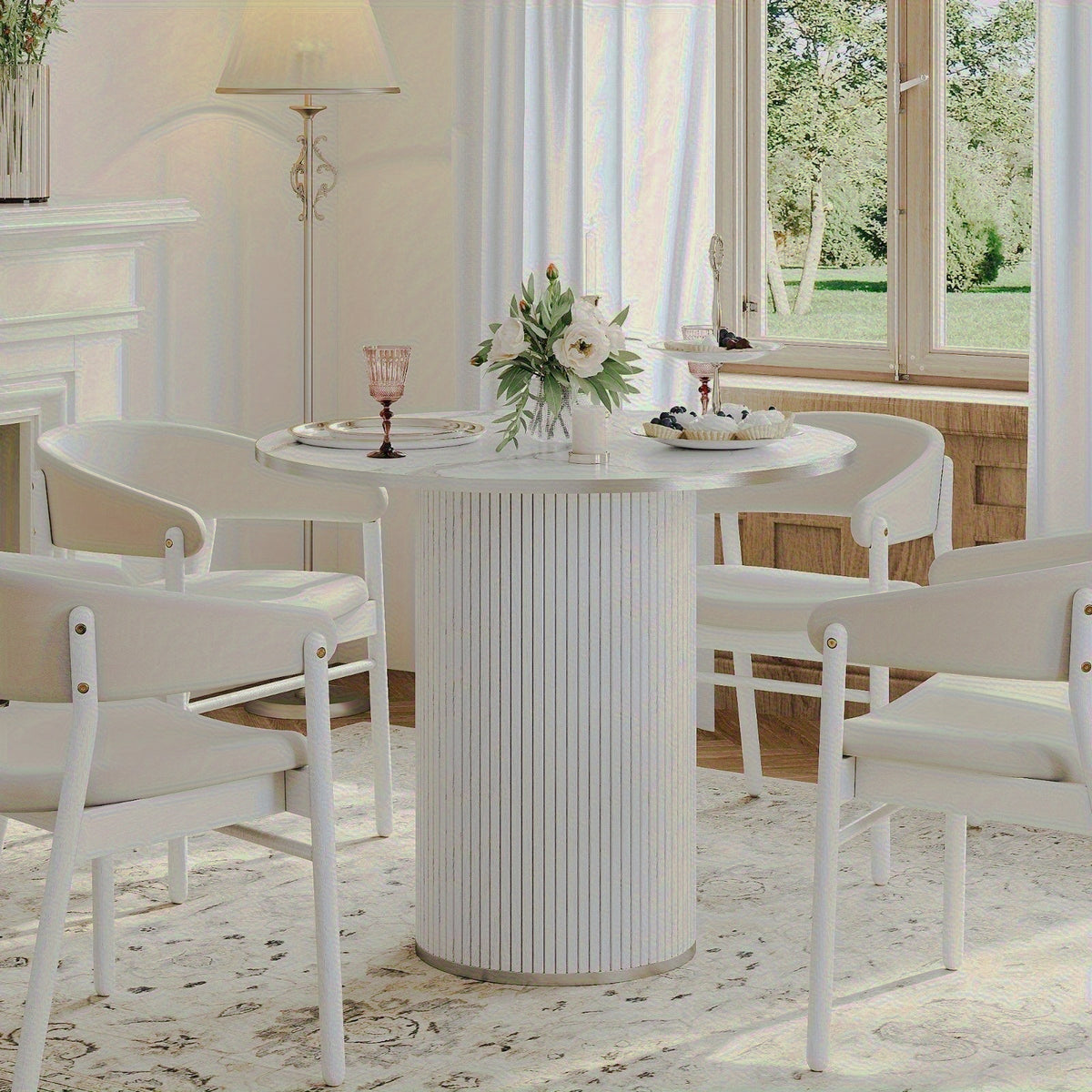 White table styled with separate dining chairs