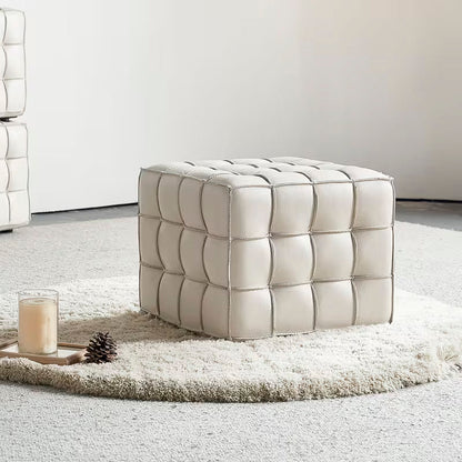 Square Tufted Ottoman — beige grid-tufted ottoman in a room