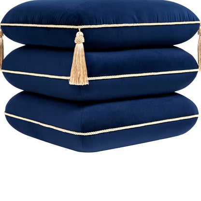 Close-up of navy cushion layers, gold piping and corner tassels