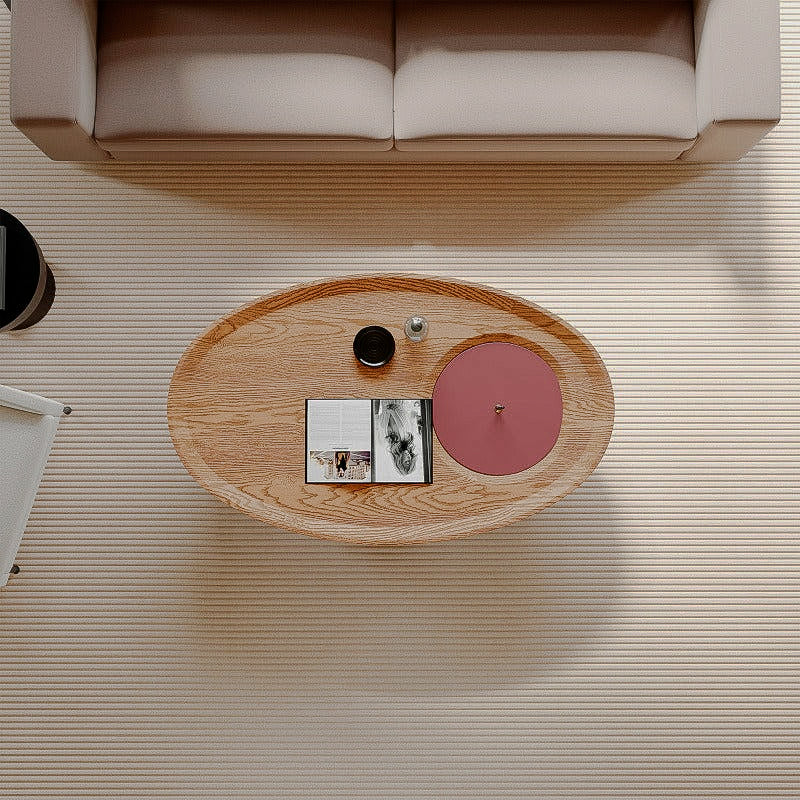 Overhead view of the oval coffee table with red lid and wood-look surface