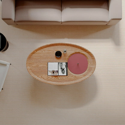 Overhead view of the oval coffee table with red lid and wood-look surface